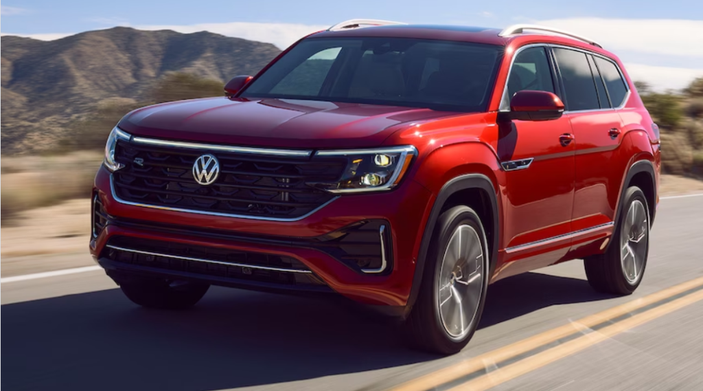 New red 2024 Volkswagen Atlas on the road.