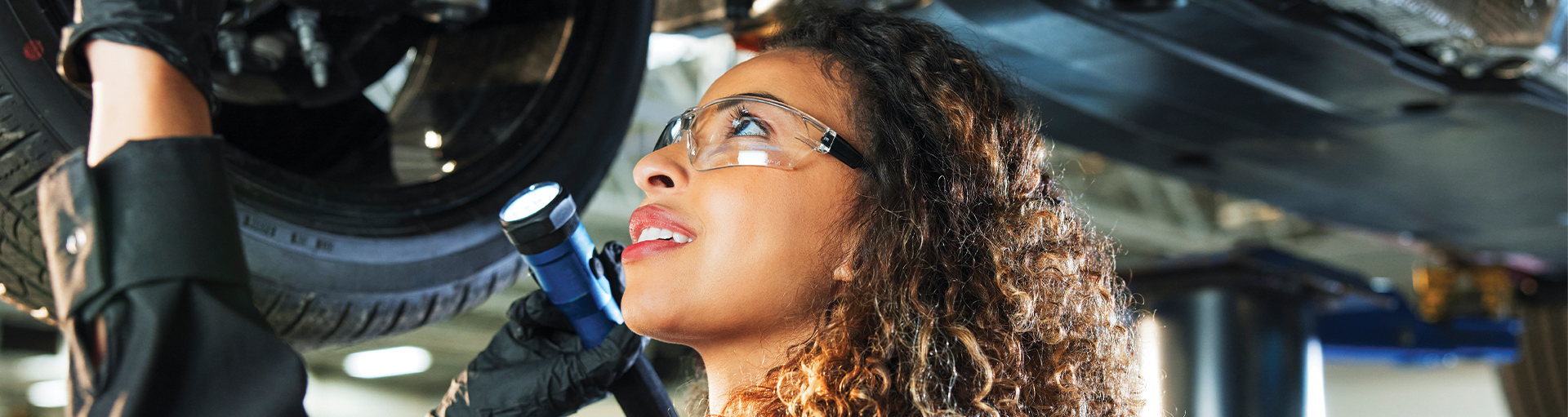 Service technician working under a vehicle.